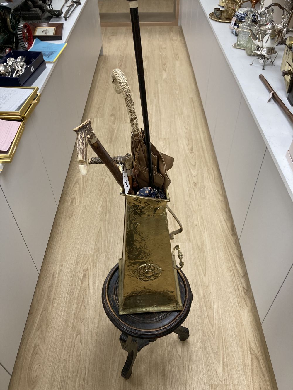 A carved tripod vase stand, an Arts & Crafts hammered brass vase, height 56cm, two umbrellas and two walking sticks